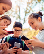 Kids Playing Video Games On Smart Phone After School