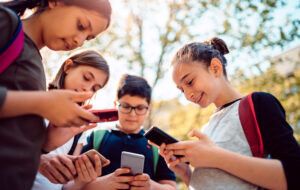 Kids Playing Video Games On Smart Phone After School